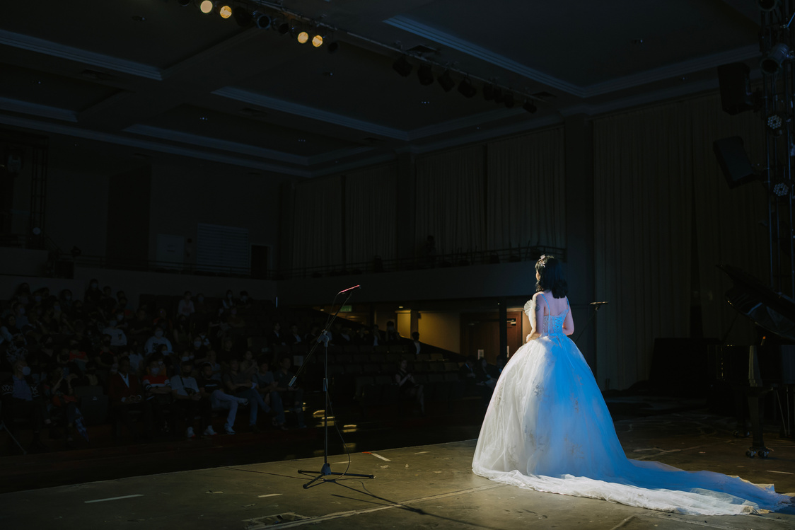 Young Chinese Female opera singer performing solo on stage